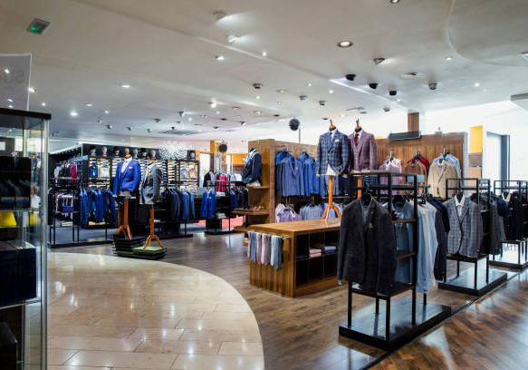 Interior of a high-quality clothing shop for men with many suits and neckties on display